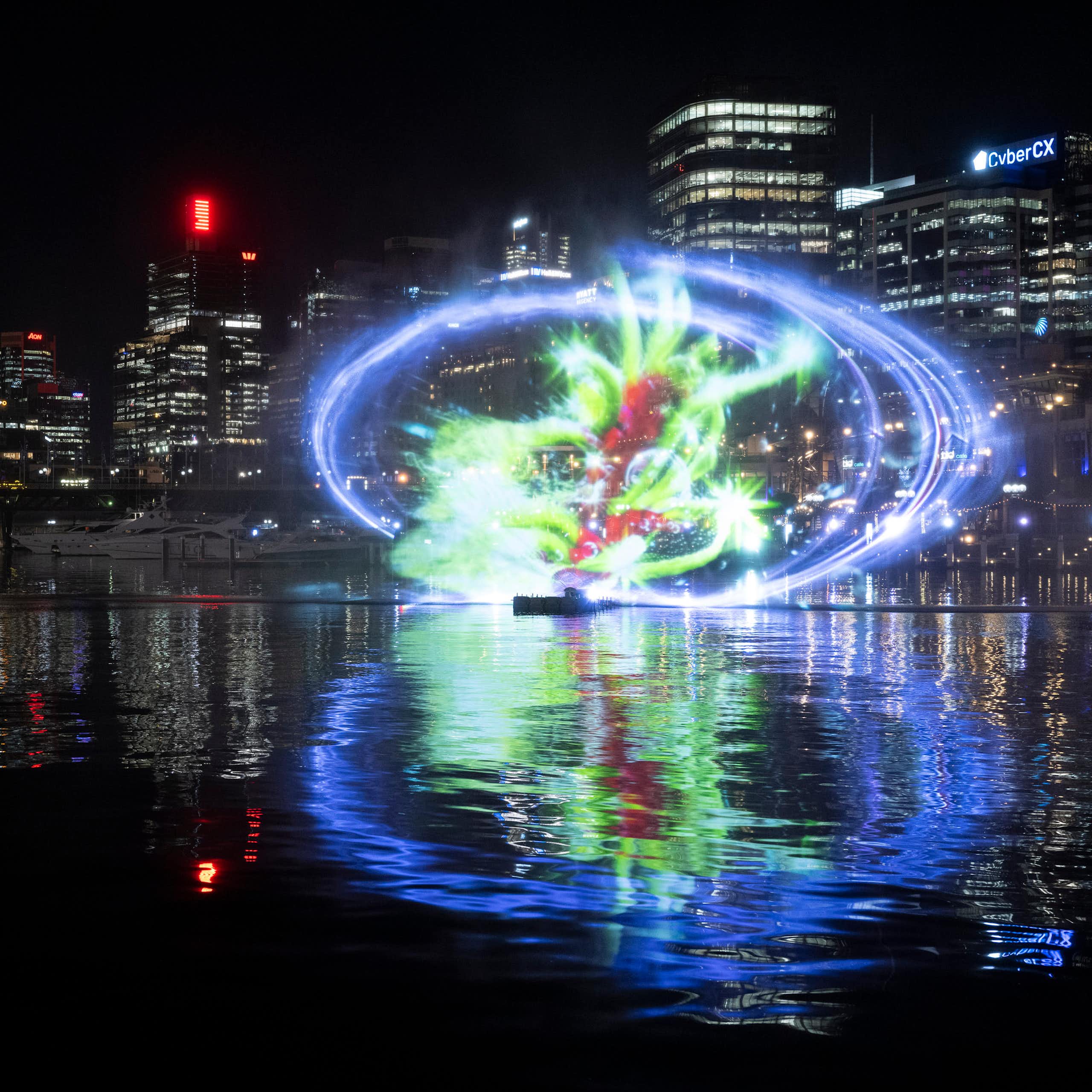 Glowing light art installation against city backdrop