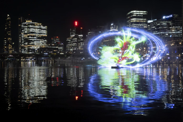 Glowing light art installation against city backdrop