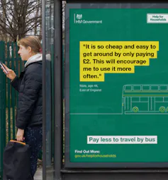 Person waits at bus stop in UK