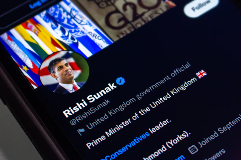 Photo of a mobile phone with Rishi Sunak's Twitter profile pulled up