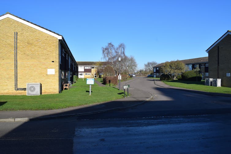 Semi-detached houses with heat pumps on the side.