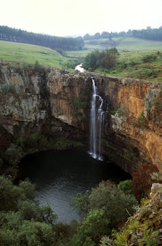 A very long and thin waterfall in the mountains