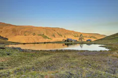 Two small houses near a lake in the Drakensberg