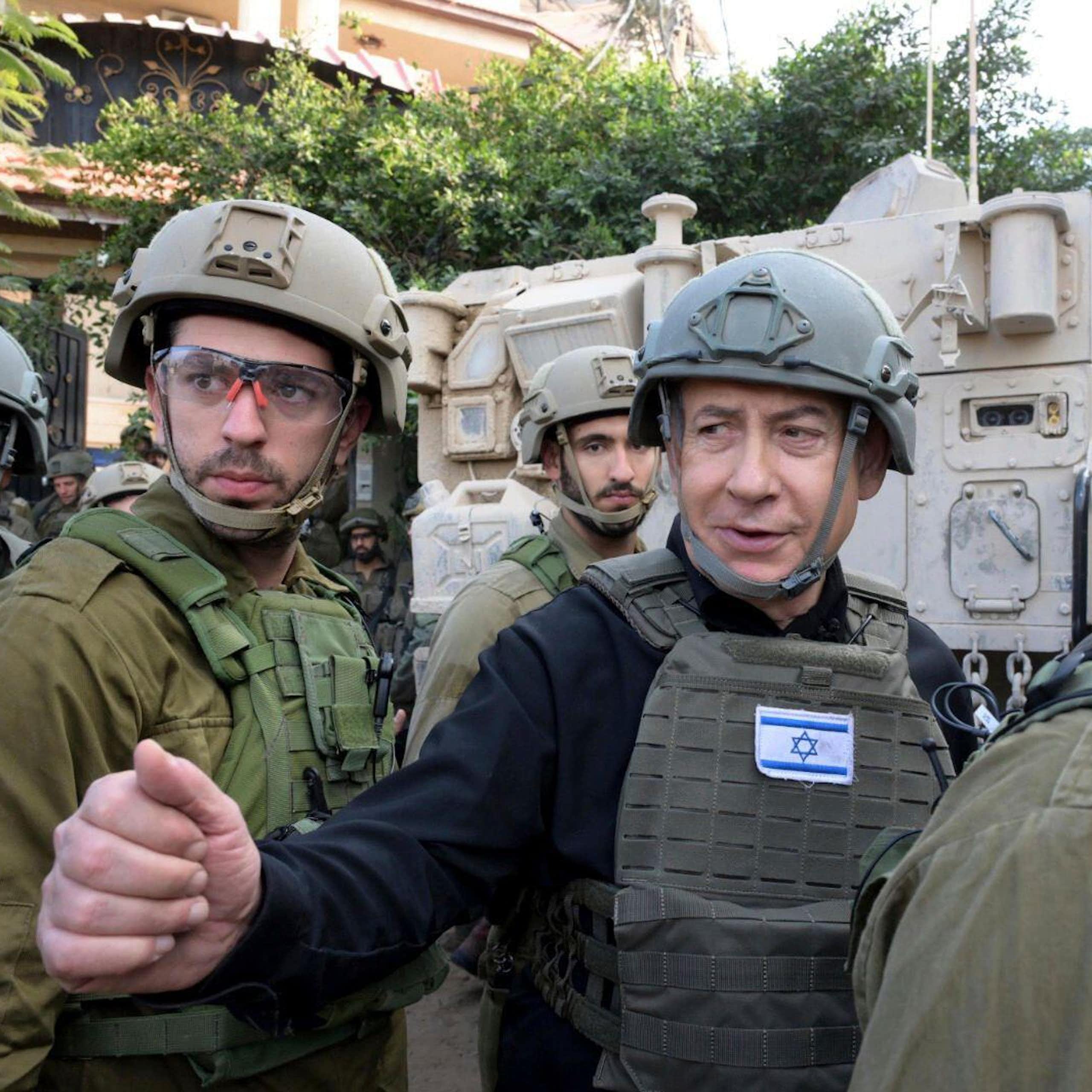 Israeli prime minister Benjamin Netanyahu dressed in combat gear with aides.