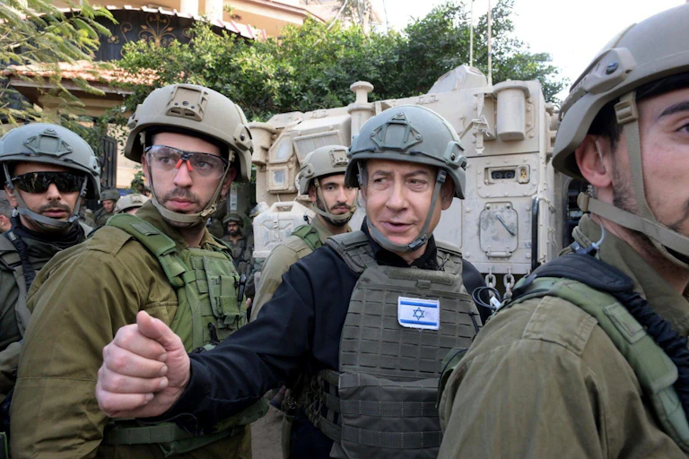 Israeli prime minister Benjamin Netanyahu dressed in combat gear with aides.
