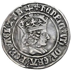 A silver coin showing the likeness of Henry VII.