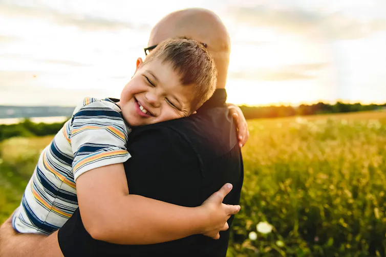 Dad hugs son