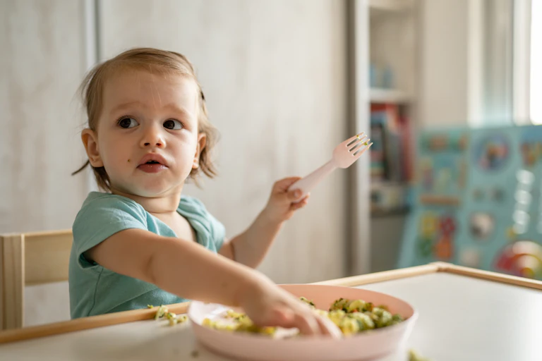 A toddler eating.