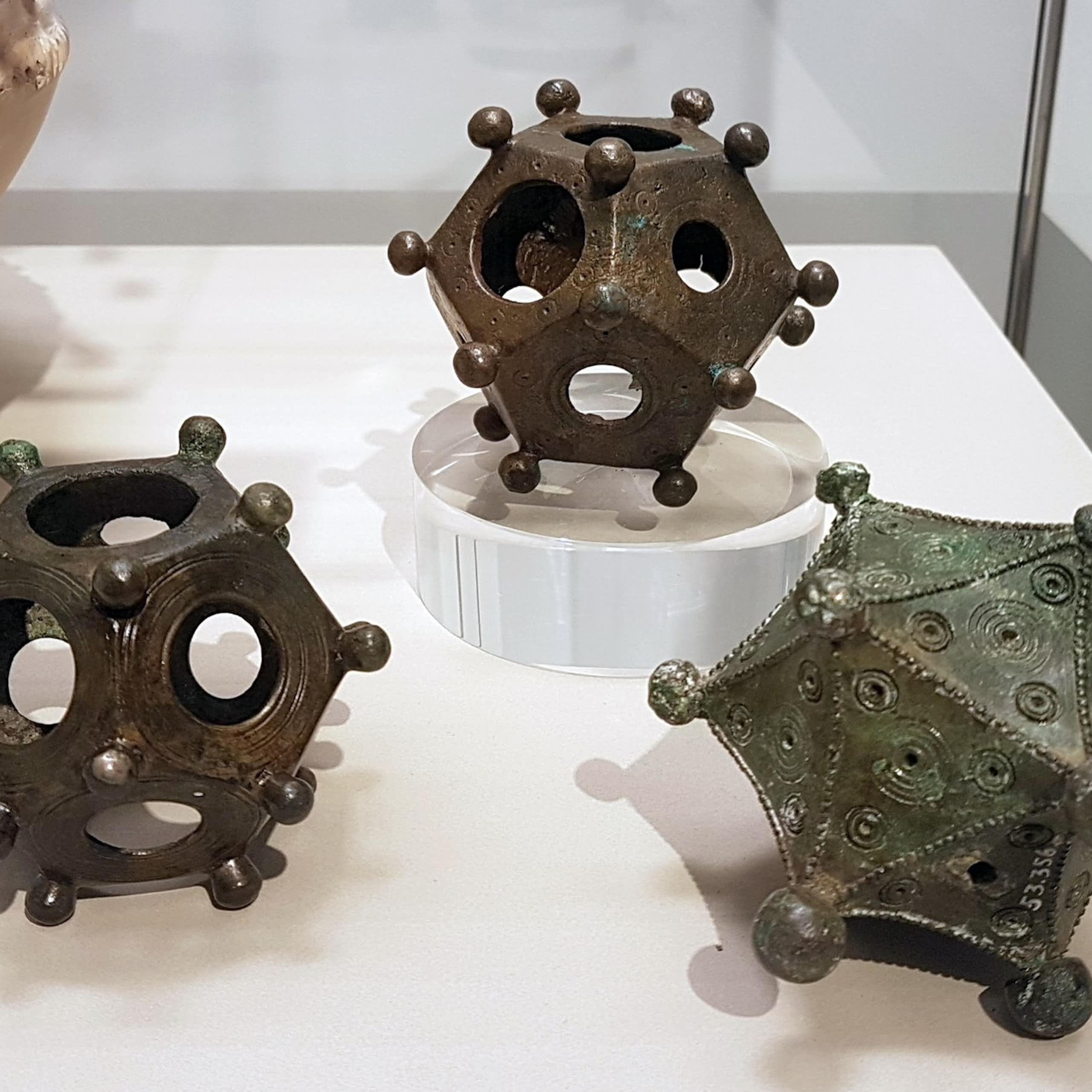 Two dodecahedra and an icosahedron on display.