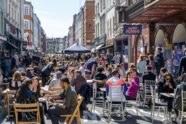 Diners and drinkers on outside tables.