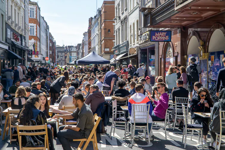 Diners and drinkers on outside tables.