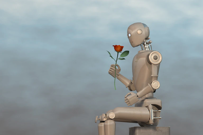 a humanoid robot sitting on a block holding a rosee too its face