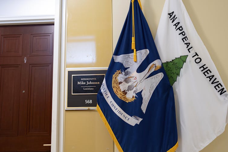 The Louisiana state flag and the 'Appeal to Heaven' flag are displayed in a hallway.