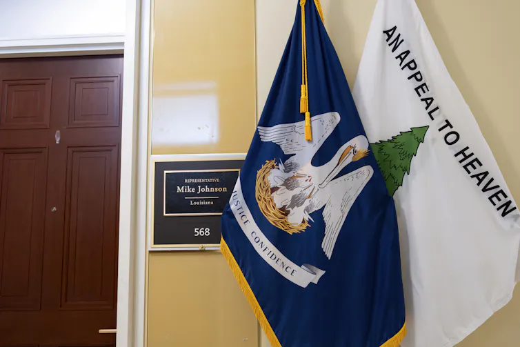 The Louisiana state flag and the 'Appeal to Heaven' flag are displayed in a hallway.