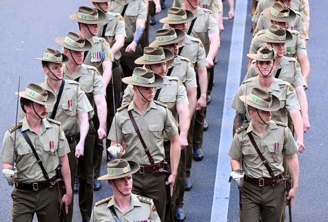 Three rows of Australian soldiers marching