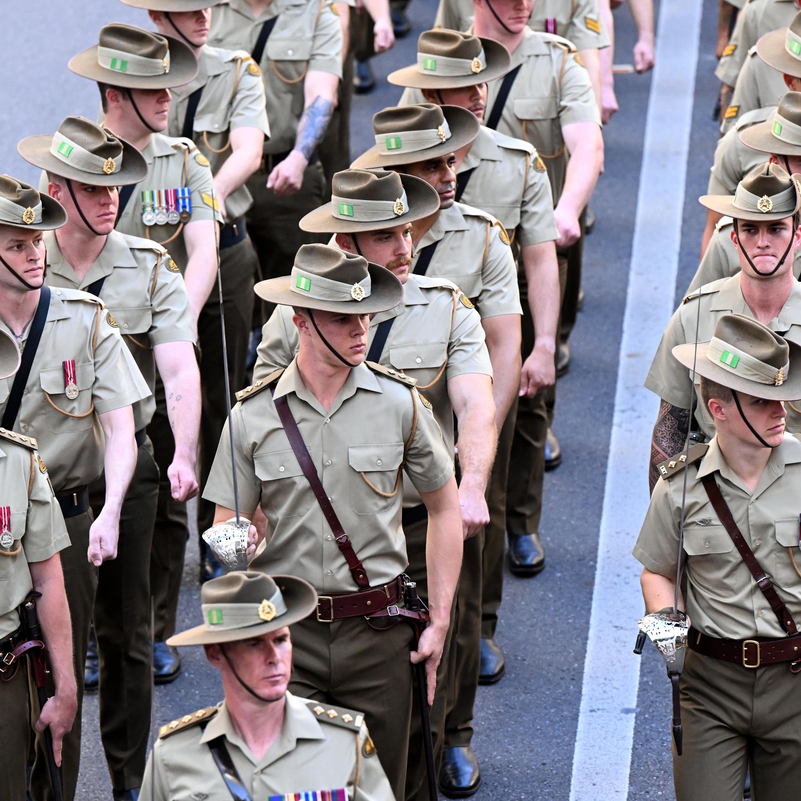Three rows of Australian soldiers marching