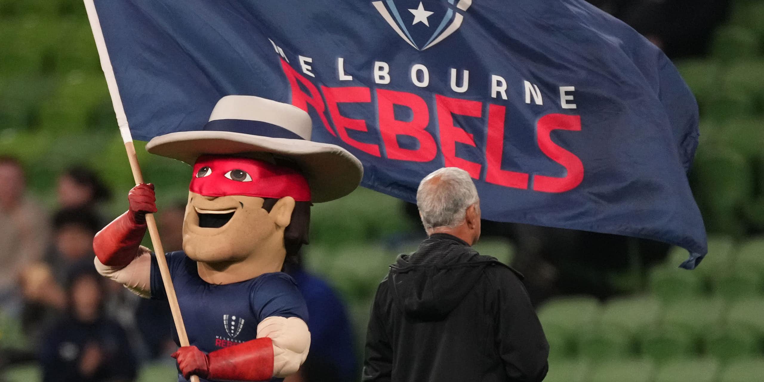 The Melbourne Rebels mascot waves the club flag during a game