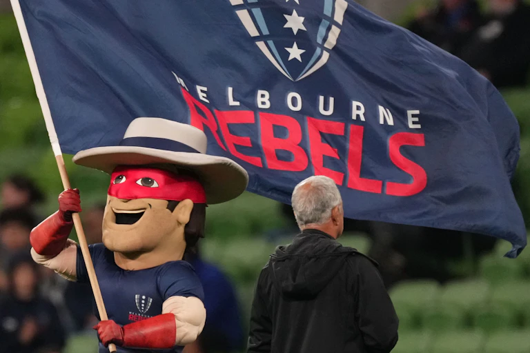 The Melbourne Rebels mascot waves the club flag during a game
