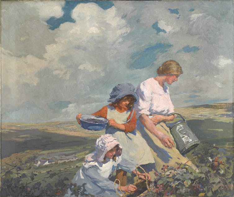 A woman and two girls picking fruit