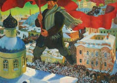 A historical painting depicting a Bolshevik floating above a crowd carrying a red flag.