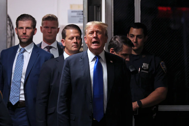 People in suits and ties stand in a group.