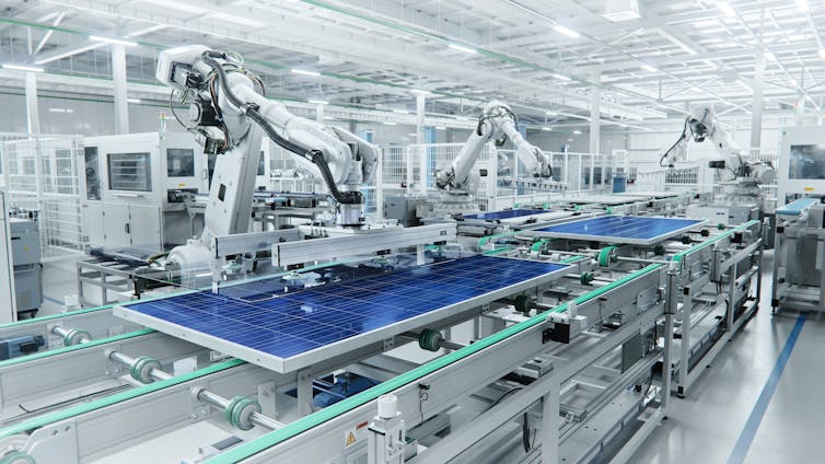 Solar panels on assembly line in factory