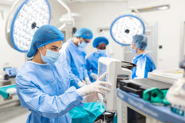 Anesthesiologist keeping track of vital functions on a monitor in a hospital