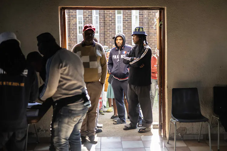 People queuing outside a polling station to cast their vote.