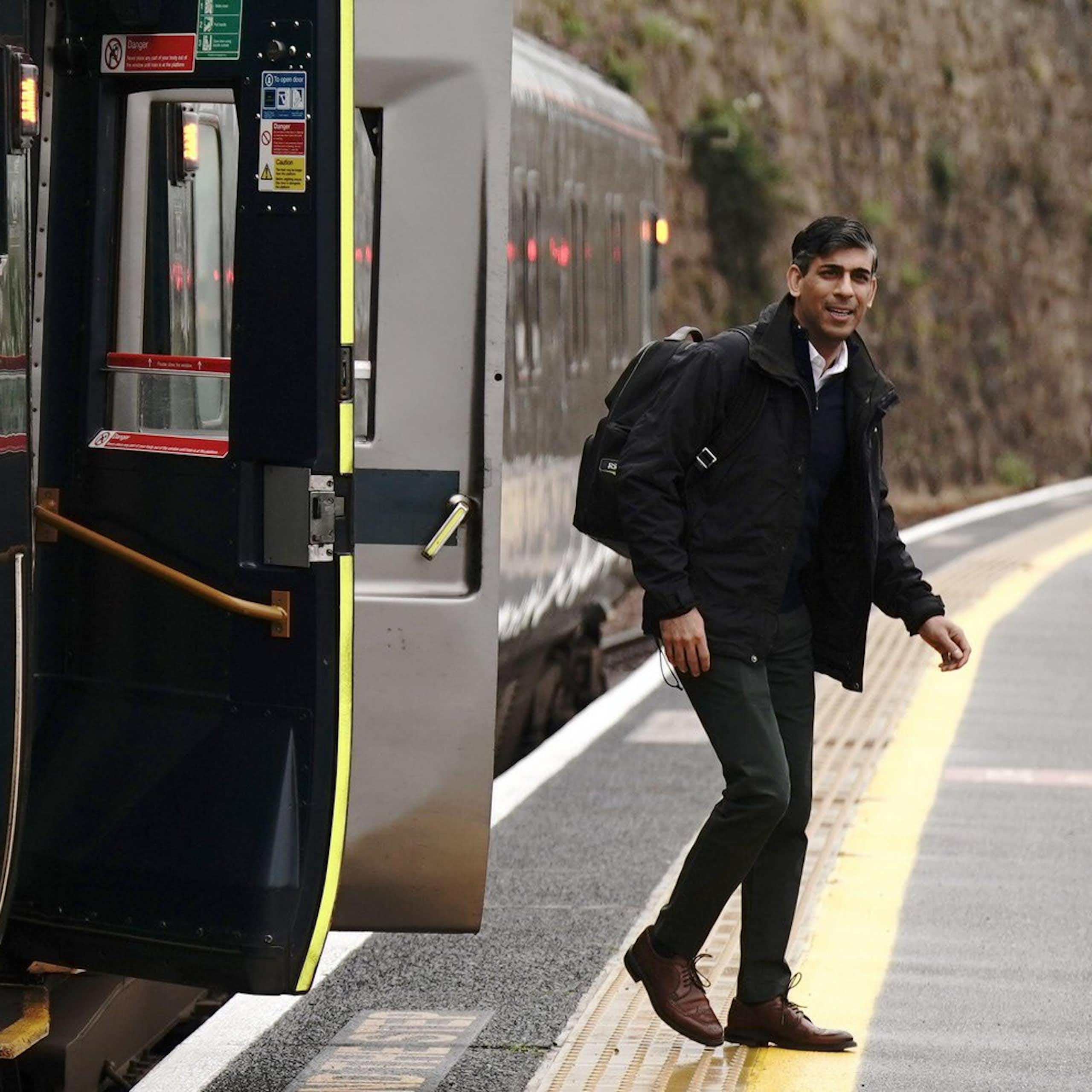 Rishi Sunak getting off a train