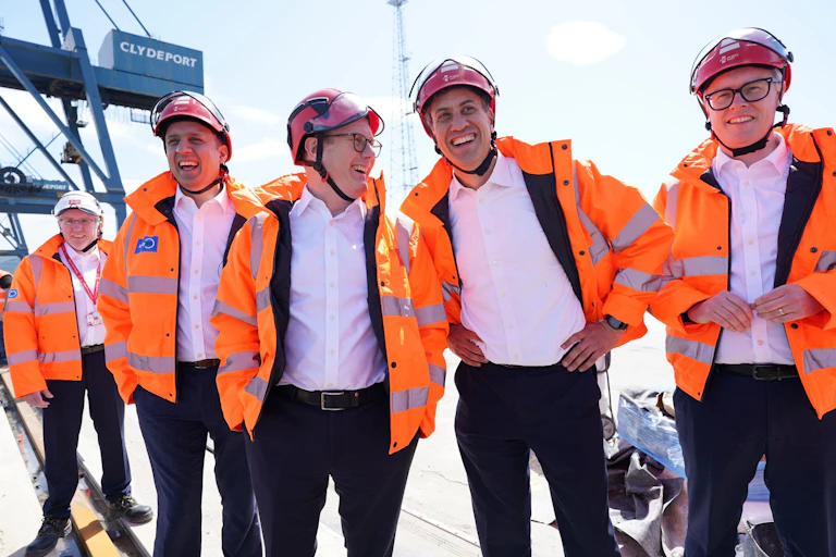 Anas Sarwar, Keir Starmer and Ed Miliband wearing helmets and high-viz jackets.