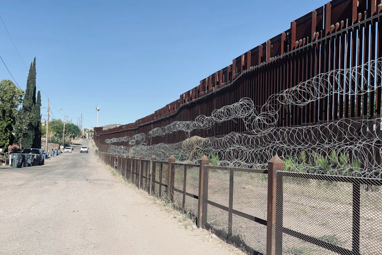 border wall with barbed wire and gates