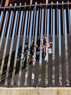 flowers hung up on security wall