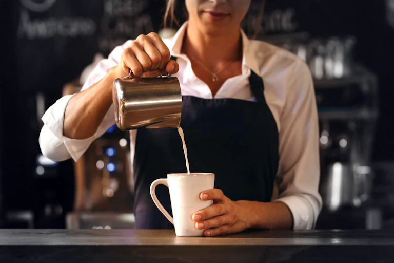 Barista pouring coffee