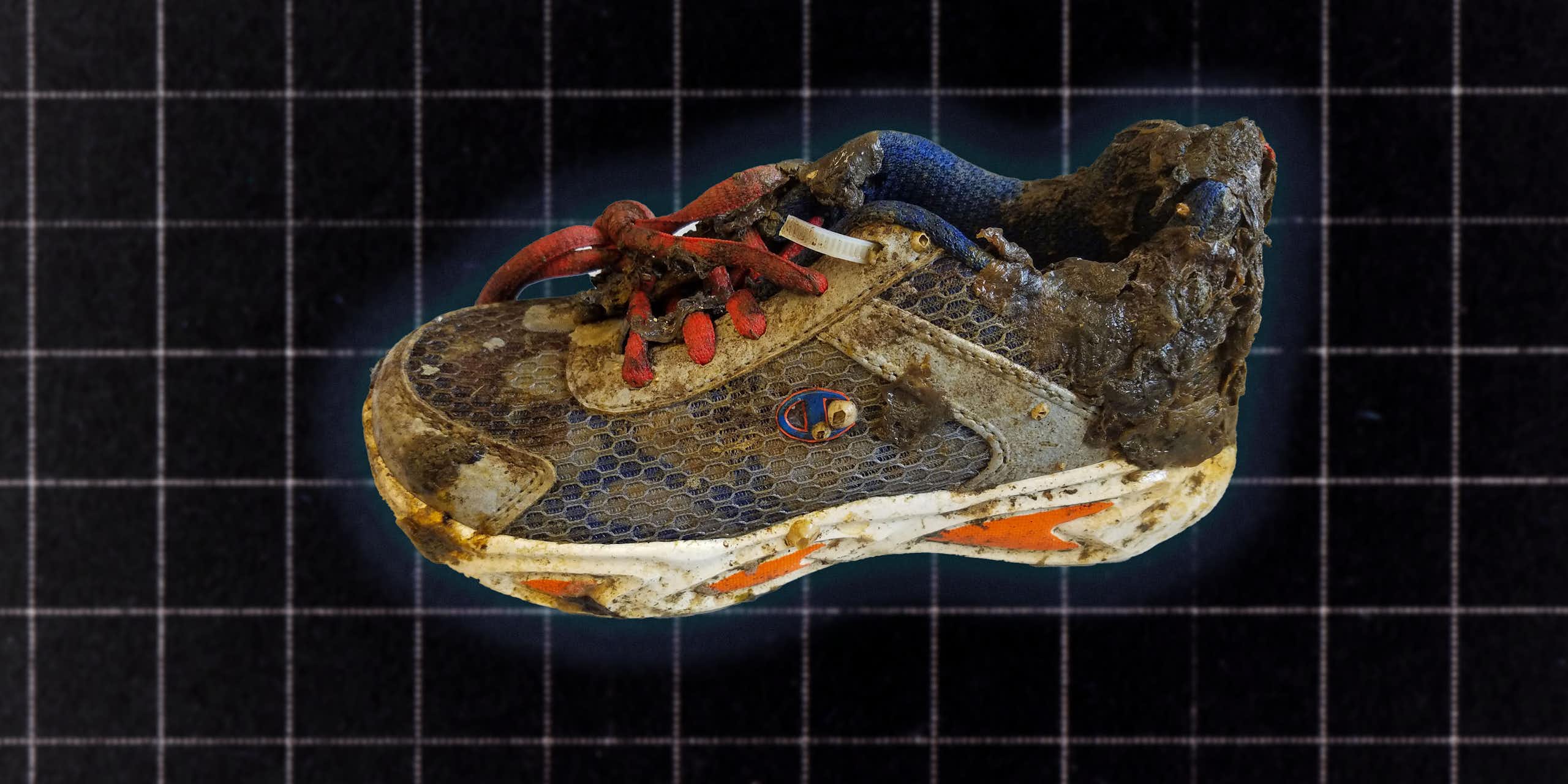 A running shoe covered in grime and barnacles displayed on a dark grid background.