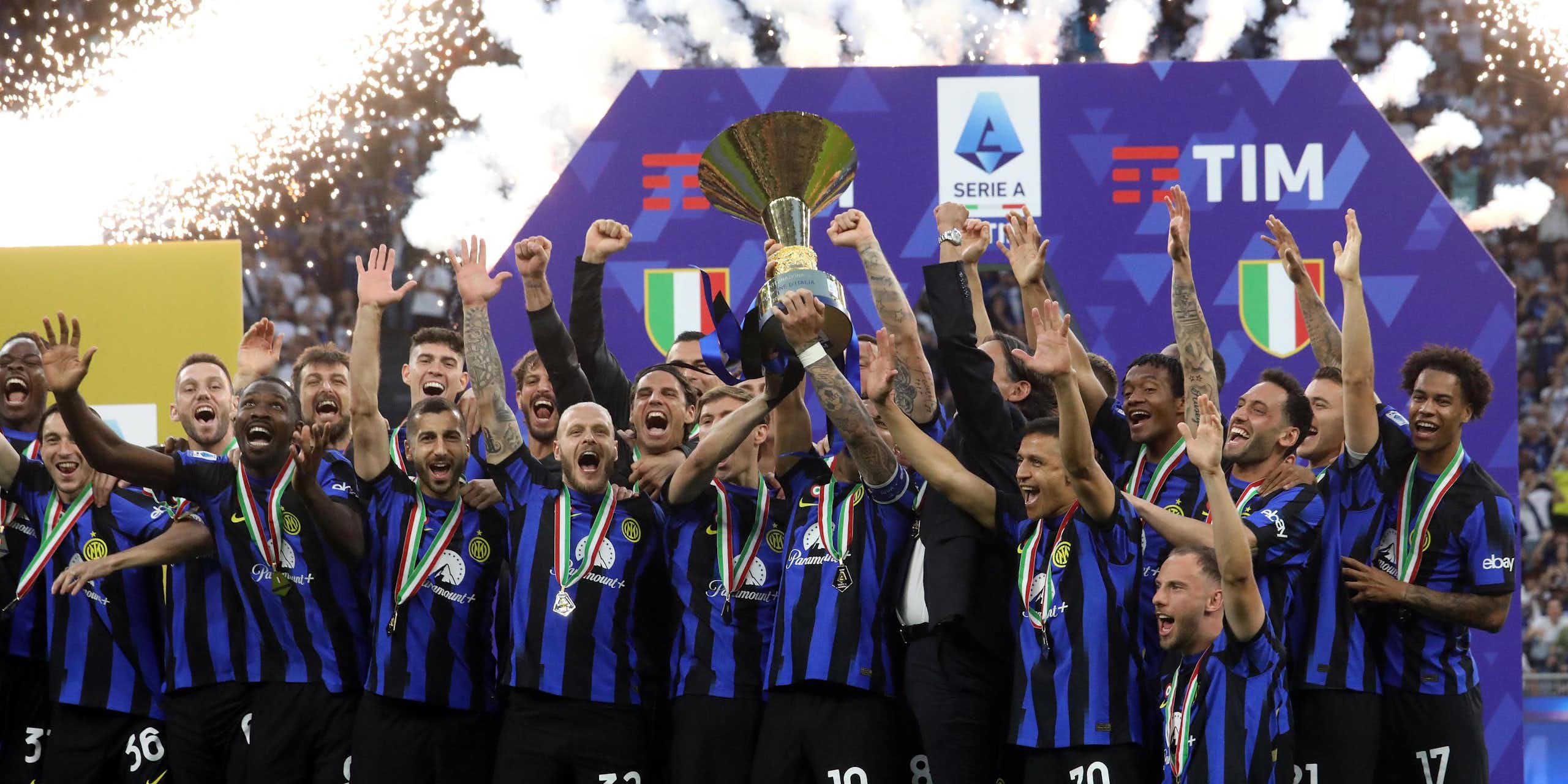 Inter Milan's squad celebrate as they lift the league winner's trophy.
