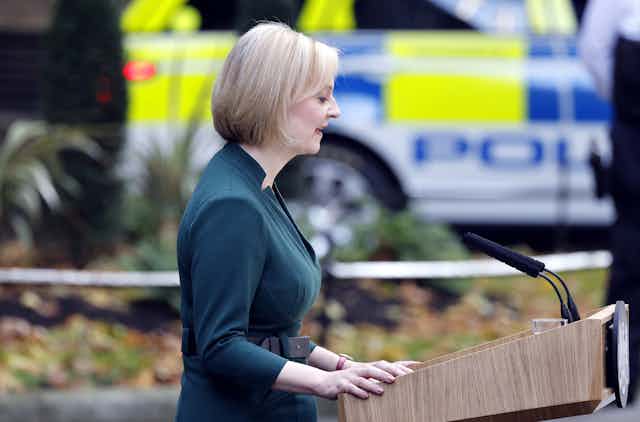 former prime minister liz truss at a lectern