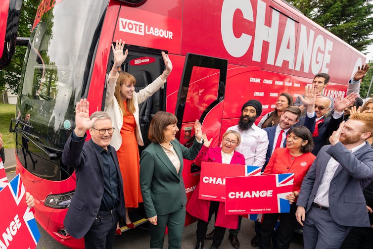 Keir Starmer, Angela Rayner and Rachel Reeves stepping off Labour's campaign bus and waving at supporters.