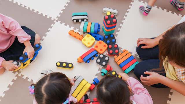 Children playing with stackable blocks.