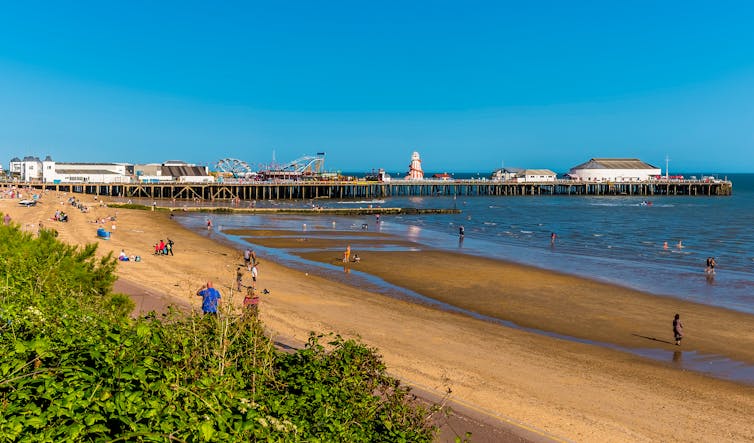 Clacton pier and beach on a sunny day.