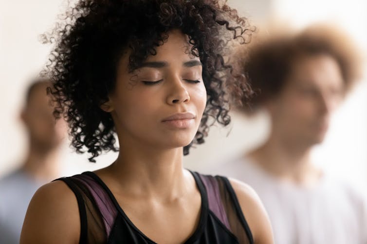 Close up of a woman with her eyes closed and a peaceful look on her face