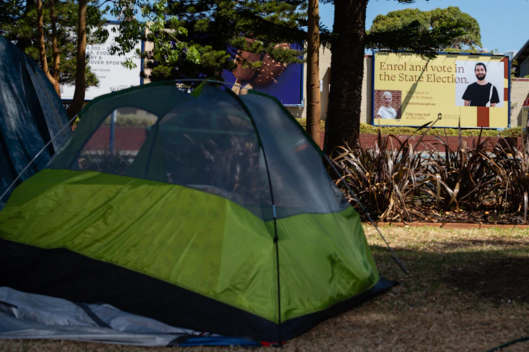 A tent is pitched in a public park