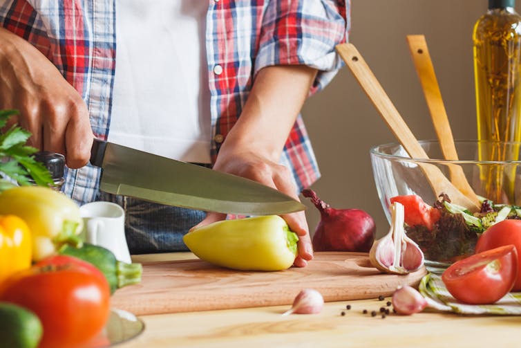 person preparing vegetables at bench