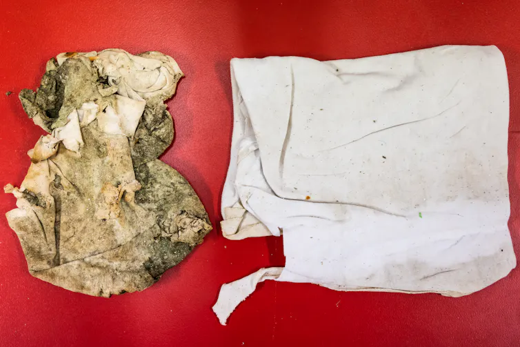 A discoloured brown and dirty piece of white fabric next to a pristine sample of the same fabric.