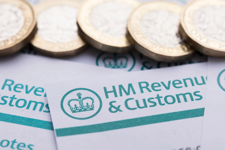pound coins and HMRC headed notepaper