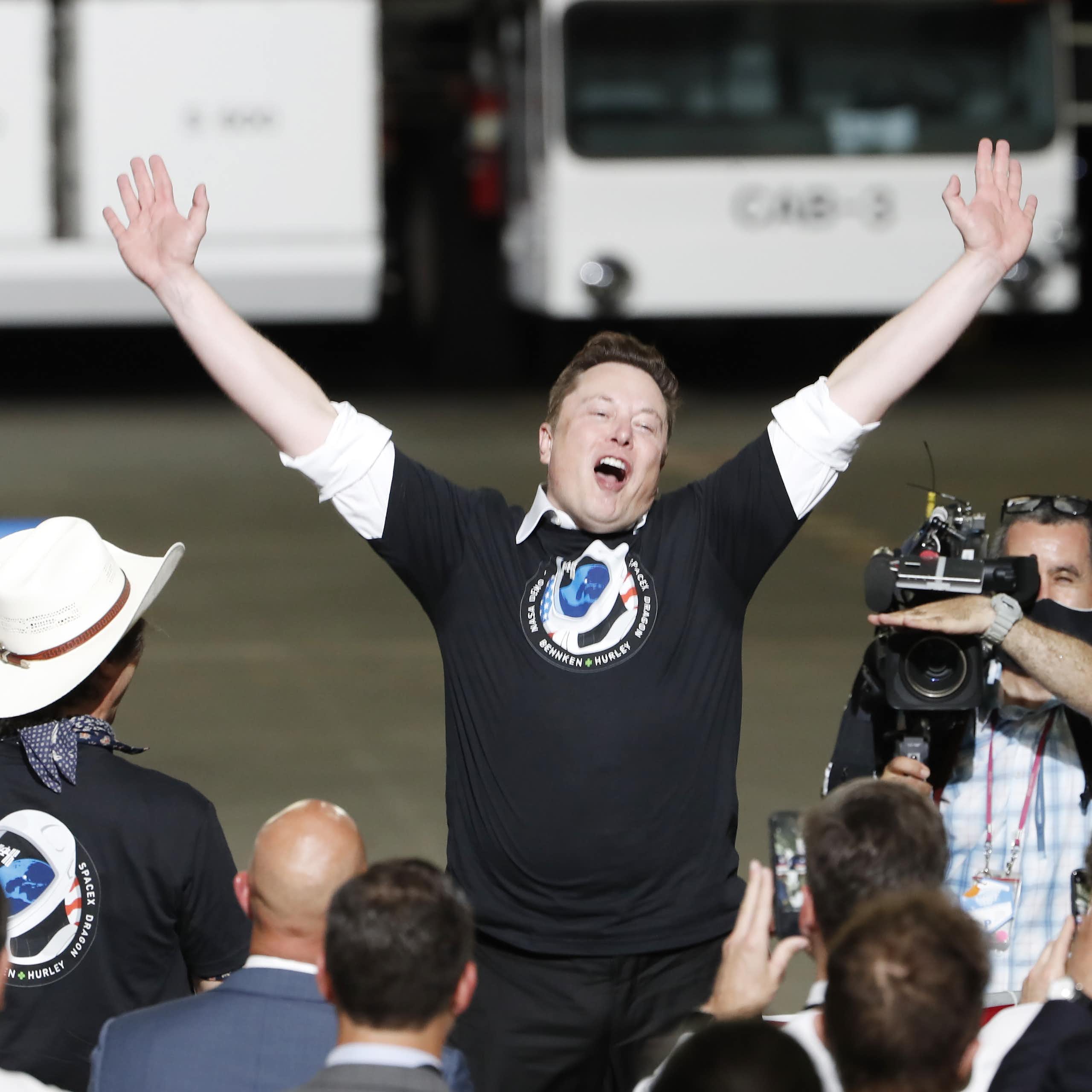 Elon Musk celebrates as SpaceX Crew Dragon Demo2 manned space mission launches from Kennedy Space Center.