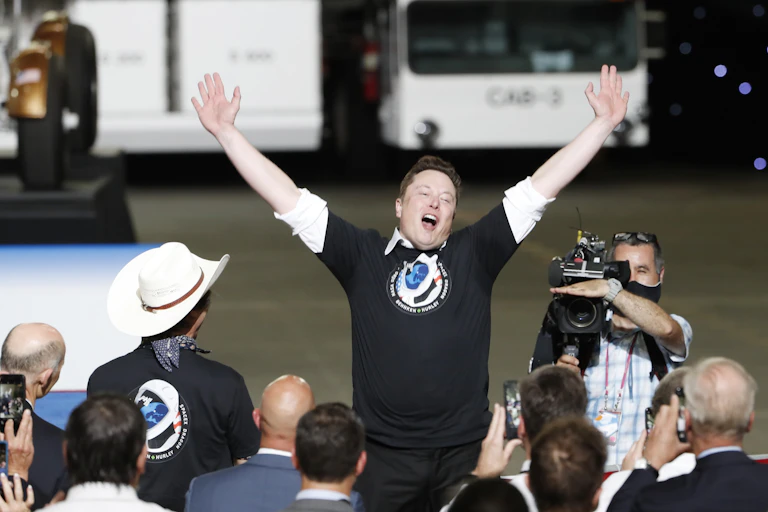 Elon Musk celebrates as SpaceX Crew Dragon Demo2 manned space mission launches from Kennedy Space Center.