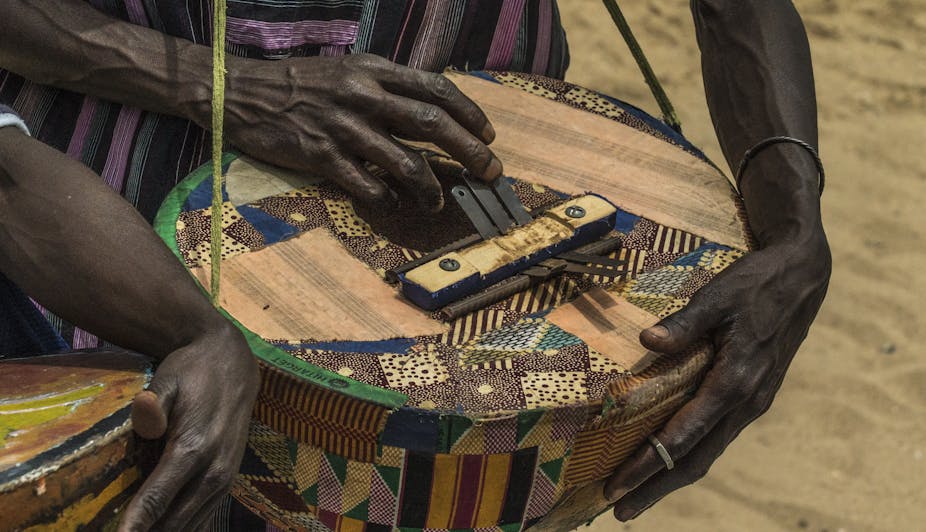 Two hands playing a traditional musical instrument