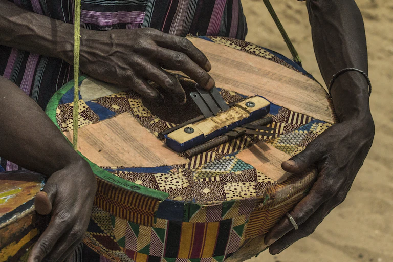 Two hands playing a traditional musical instrument