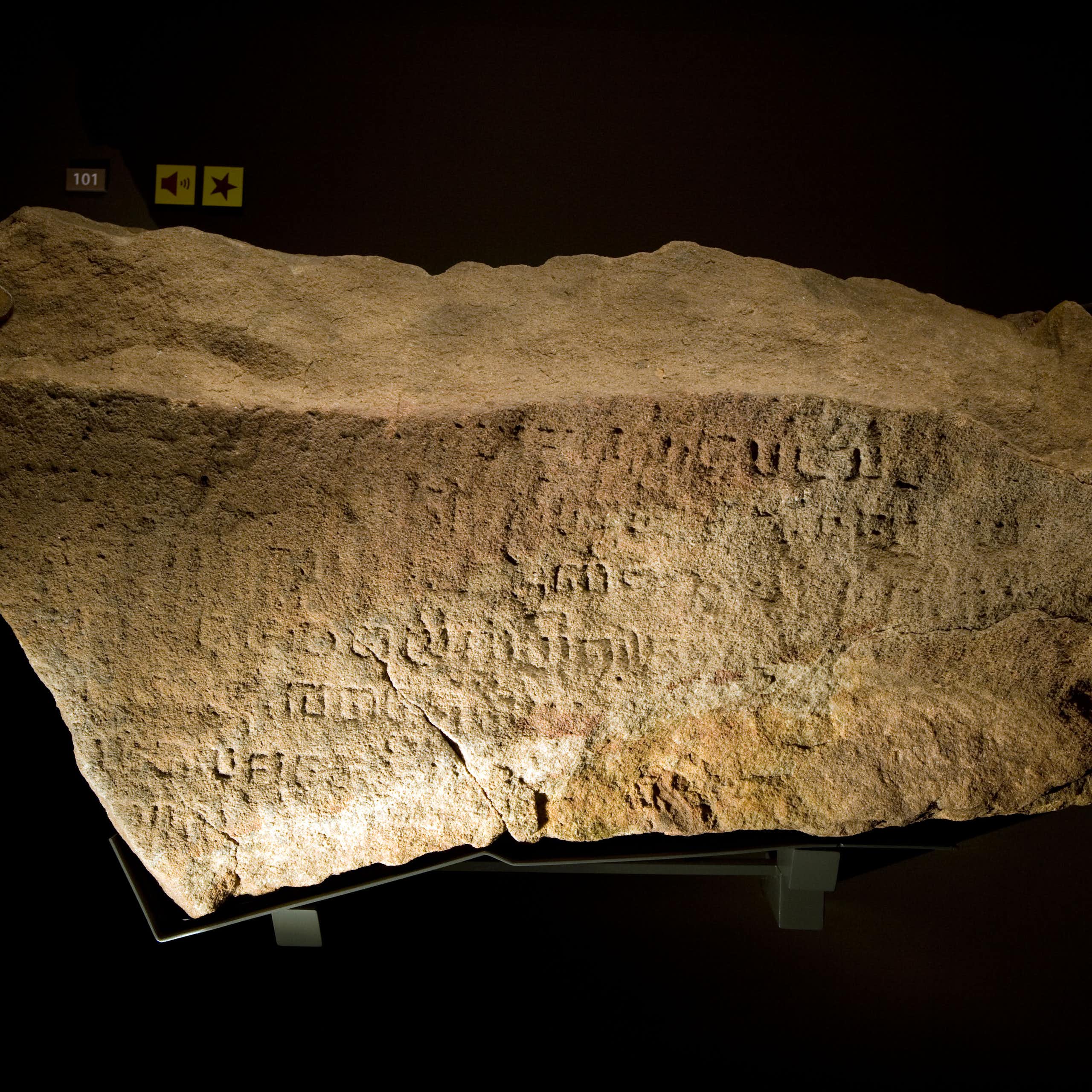 A chunk of stone covered in inscriptions.