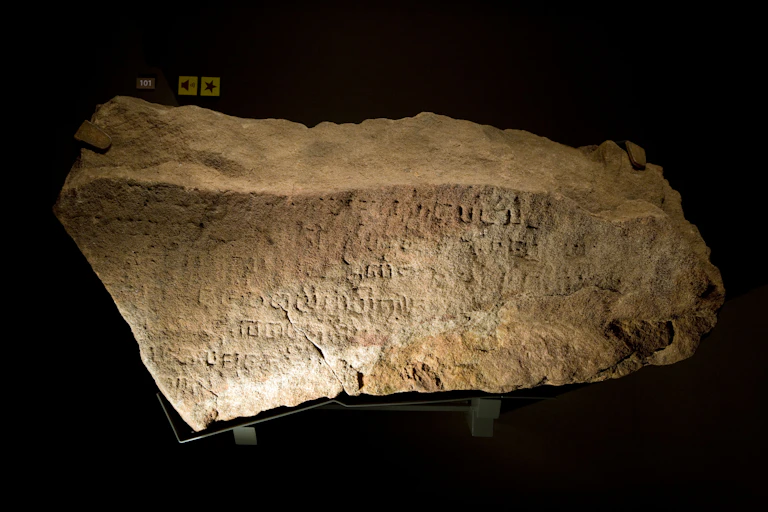 A chunk of stone covered in inscriptions.